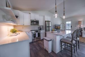 a kitchen with white cabinets and a counter top at Bridge Creek Inn in Clayton