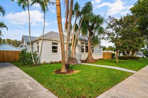 a white house with palm trees in a yard at Poolside Getaway, Close To Dt Coastal Beach in West Palm Beach