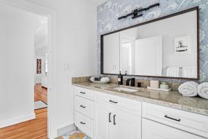 a bathroom with a sink and a large mirror at Poolside Getaway, Close To Dt Coastal Beach in West Palm Beach +31 photos