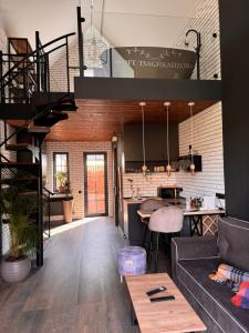 a loft apartment with a spiral staircase and a living room at Loft Tsaghkadzor in Tsaghkadzor