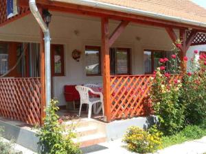 a porch of a house with a table and chairs at Rózsakert Apartman 2 in Poroszló +10 photos