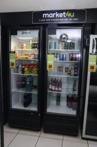 a refrigerator with its door open in a store at Apartamento aconchegante no bairro Liberdade in Sao Paulo