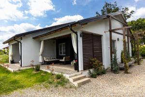 a small white house with a door and a porch at Gora Apartments 3 in Vrdnik