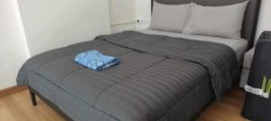 a bed with a blue pillow on top of it at Laguna Beach Resort 2 Jomtien in Pattaya Central