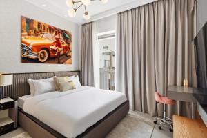 a hotel room with a bed and a car on the wall at Serene Haven Cozy Community Courtyard View in Dubai +32 photos