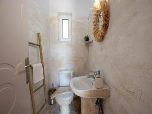 a bathroom with a sink and a toilet at Alavastros Villa Maisonettes in Vasilikos +35 photos
