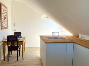 a kitchen with a table and chairs in a attic at Zieleckblick in Bad Sooden-Allendorf +8 photos