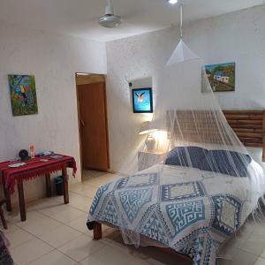 Voodi või voodid majutusasutuse Mayan Bungalow Near Chichén toas