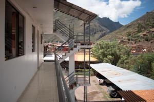 a balcony with stairs and a view of a mountain at Hotel Everest in Pisac