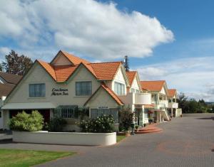 a row of houses with orange roofs on a street at Rotorua Coachman Spa Motel in Rotorua