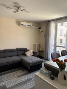 Una sala de estar con un sofá y una ventana. en Elegant Apartment Terrace Port of Nice, en Niza