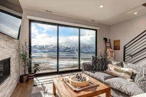 a living room with a couch and a large window at Klaim Retreats 807 in Park City +52 photos