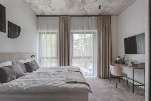 Postel nebo postele na pokoji v ubytování LAJOS Hotel