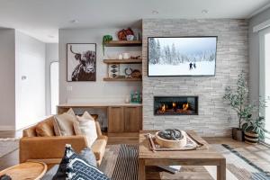 a living room with a couch and a fireplace at Klaim Retreats 807 in Park City
