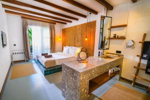 a hotel room with a bed and a bathroom at Very Chic Bodrum Adult Only in Gümbet