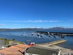 a bunch of boats are docked in a harbor at Apartamento El Puerto III-Finisterre in Fisterra