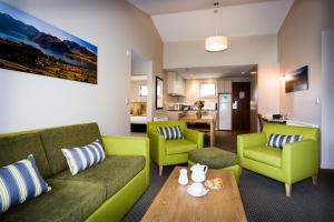 a living room with a couch and two chairs and a table at Club Wyndham Wanaka, Trademark Collection by Wyndham in Wanaka
