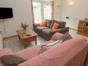 a living room with a couch and a table at The Packing House in Penzance