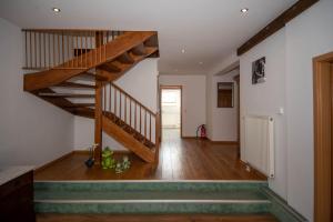 a hallway with a wooden staircase in a house at Ferienwohnung in Xanten auf dem Moerenhof in Xanten