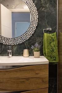 a bathroom with a sink and a mirror at Mirela's golden luxury apartment in Split