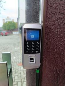 a cell phone is attached to a wall at Residencial Luce Del Sole Apt 3 in Joinville +48 photos