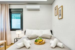 a room with a bed with a basket of fruit on it at Virginia Haven in Chios