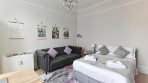 a living room with a couch and a couch and a table at Stylish York Studio in York