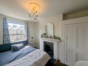 Ένα ή περισσότερα κρεβάτια σε δωμάτιο στο TopHome Arsenal