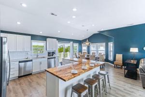 a kitchen with a large island with a wooden counter top at Southern Paws in Southern Shores