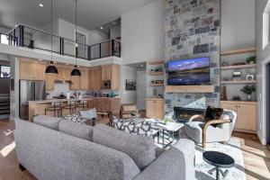 a living room with two couches and a fireplace at Mayflower Village 991 in Heber City