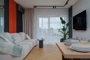 salon z białą kanapą i stołem w obiekcie Apartament Family Green z garażem, klimatyzacją do 6 osób w Warszawie