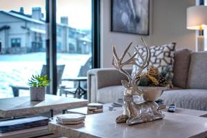 a living room with a table with a deer statue on it at Mayflower Village 991 in Heber City +73 photos