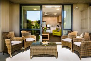a patio with wicker chairs and a table at Club Wyndham Wanaka, Trademark Collection by Wyndham in Wanaka
