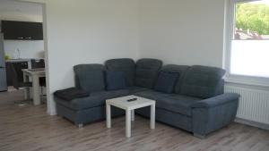 a living room with a couch and a table at Ferienwohnung Okerblick in Goslar +14 photos