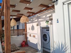 a laundry room with a washing machine in a house at MOUSELIS APARTMENTS in Kalymnos
