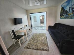 a living room with a couch and a table at Blue Apartament Braila in Brăila