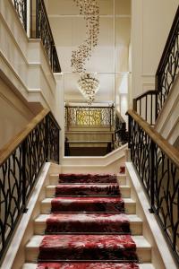 a stairway with a red carpet and a chandelier at The St. Regis Osaka in Osaka +131 photos