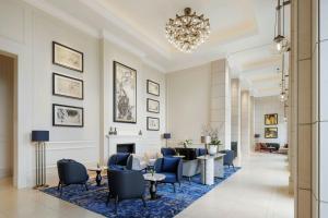 a hotel lobby with a chandelier and blue chairs at The St. Regis Osaka in Osaka