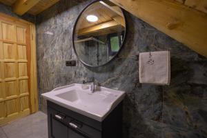 a bathroom with a sink and a mirror at Nanus Ayder Bungalow and Breakfast in Çamlıhemşin