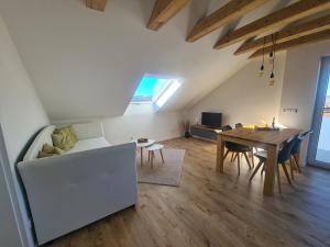 a living room with a table and a dining room at Connys FeWo Tal in Großengstingen
