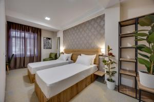 Letto o letti in una camera di Regraph Hotel