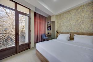 Letto o letti in una camera di Regraph Hotel
