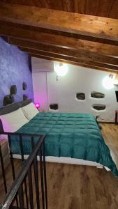 a bedroom with a bed with a green comforter at Il Rustico in Pozzillo +84 photos