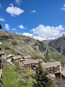 a village with snow covered mountains in the background at Résidence Queyrelet Ii - 2 pièces cabine 6 personnes MAE-2816 in Orcières +7 photos