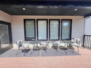 a group of tables and chairs on a porch at Morning Dew105 in Hammonds Plains
