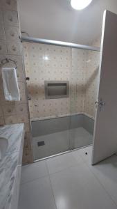 a bathroom with a shower with a glass door at Happy Hotel Garvey Park in Brasília +13 photos