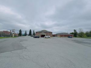 an empty parking lot in front of a building at Hilltop Inn in Barre