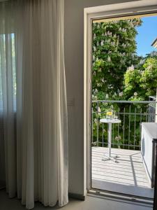 a sliding glass door leading to a balcony with a table at Home From Home - Kraków, Podgórze in Kraków
