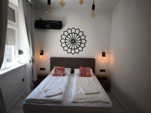 a bedroom with a bed with two pillows on it at Apartment Fedora Old Town Sarajevo in Sarajevo