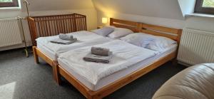 a bedroom with two beds with towels on them at Vila Jedľa in Starý Smokovec